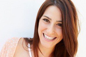 A smiling woman with auburn hair